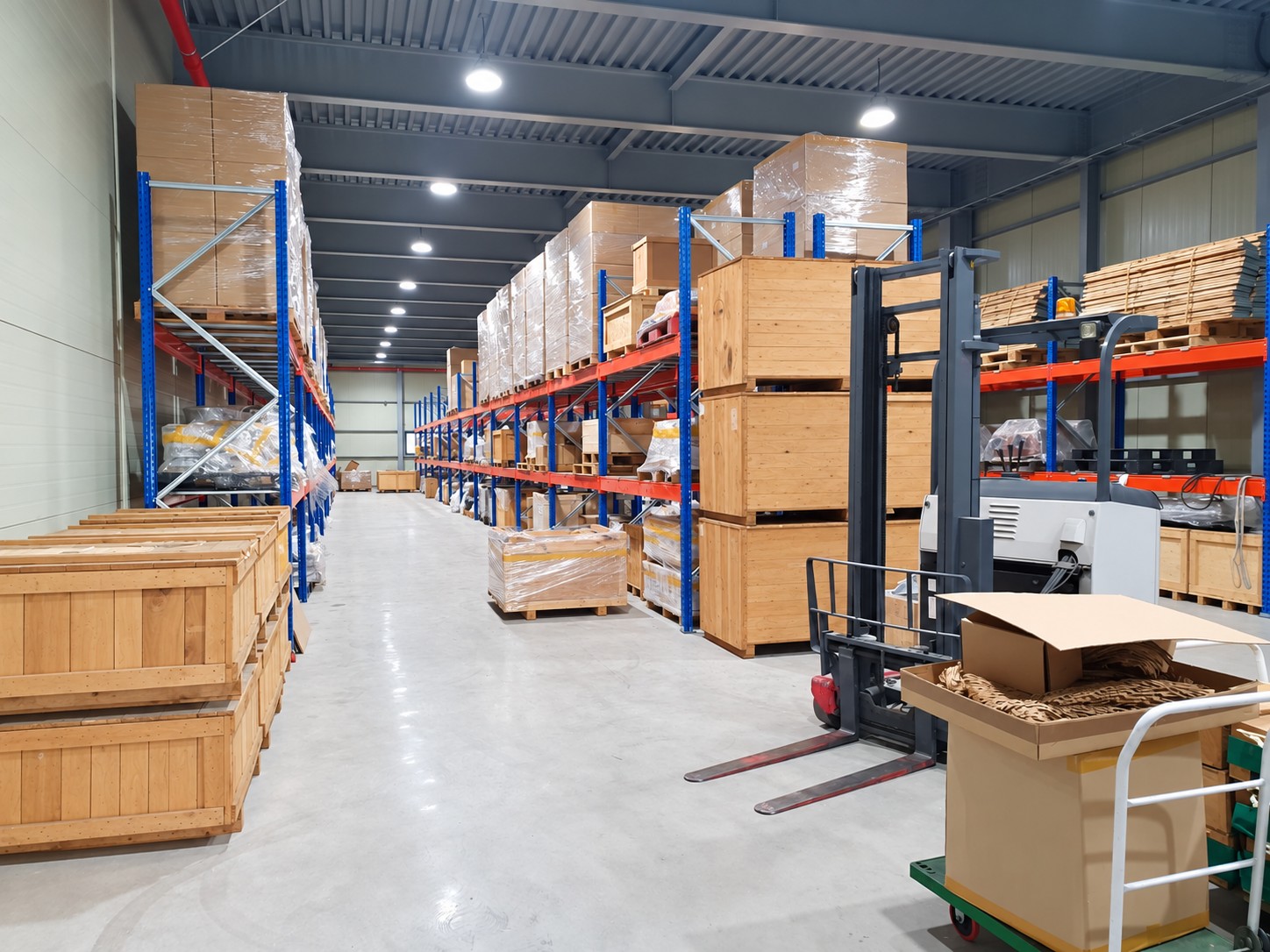 Warehouse aisle lined with boxed and crated inventory