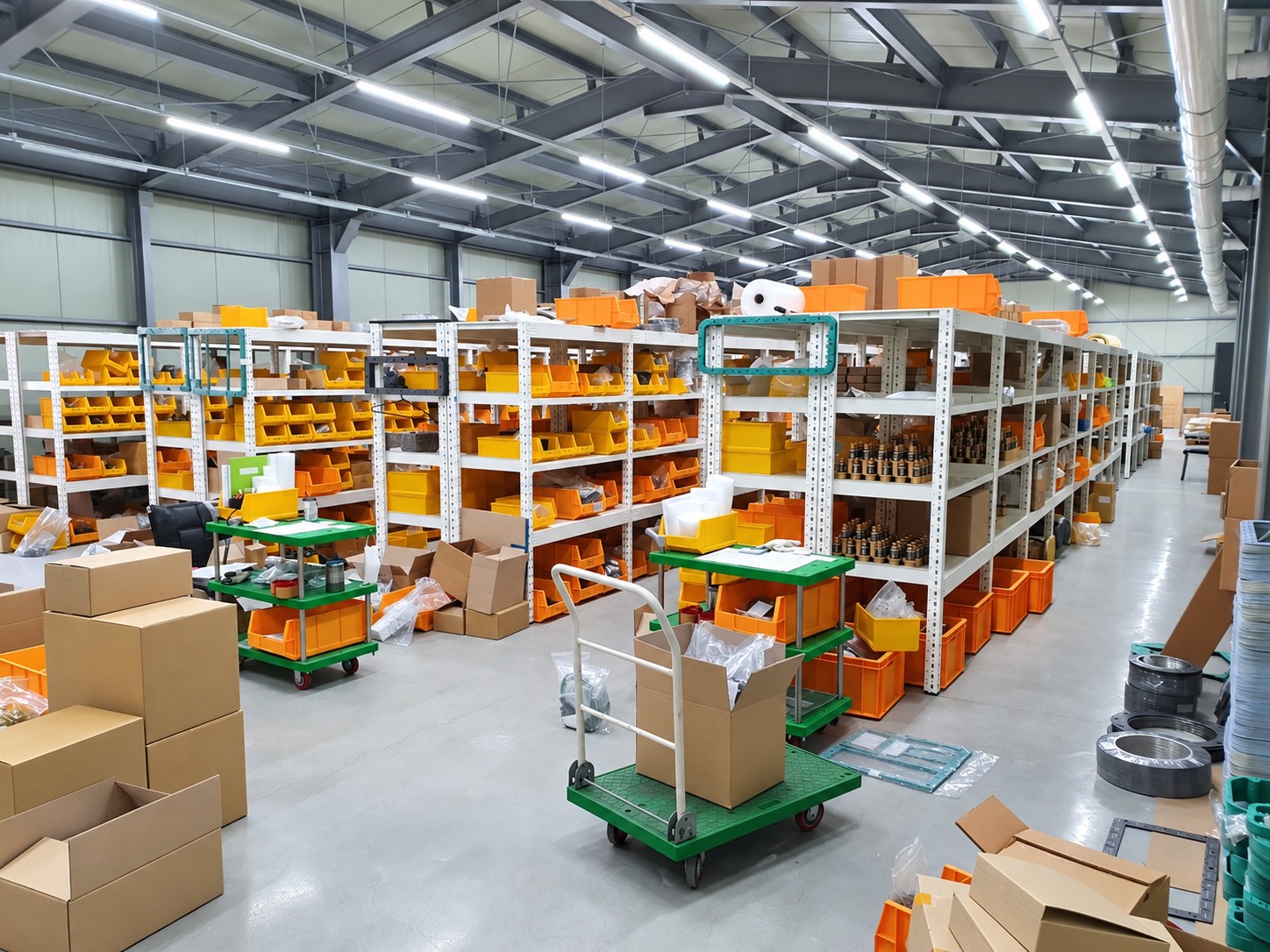 Warehouse shelving with numerous boxes and stored spare parts