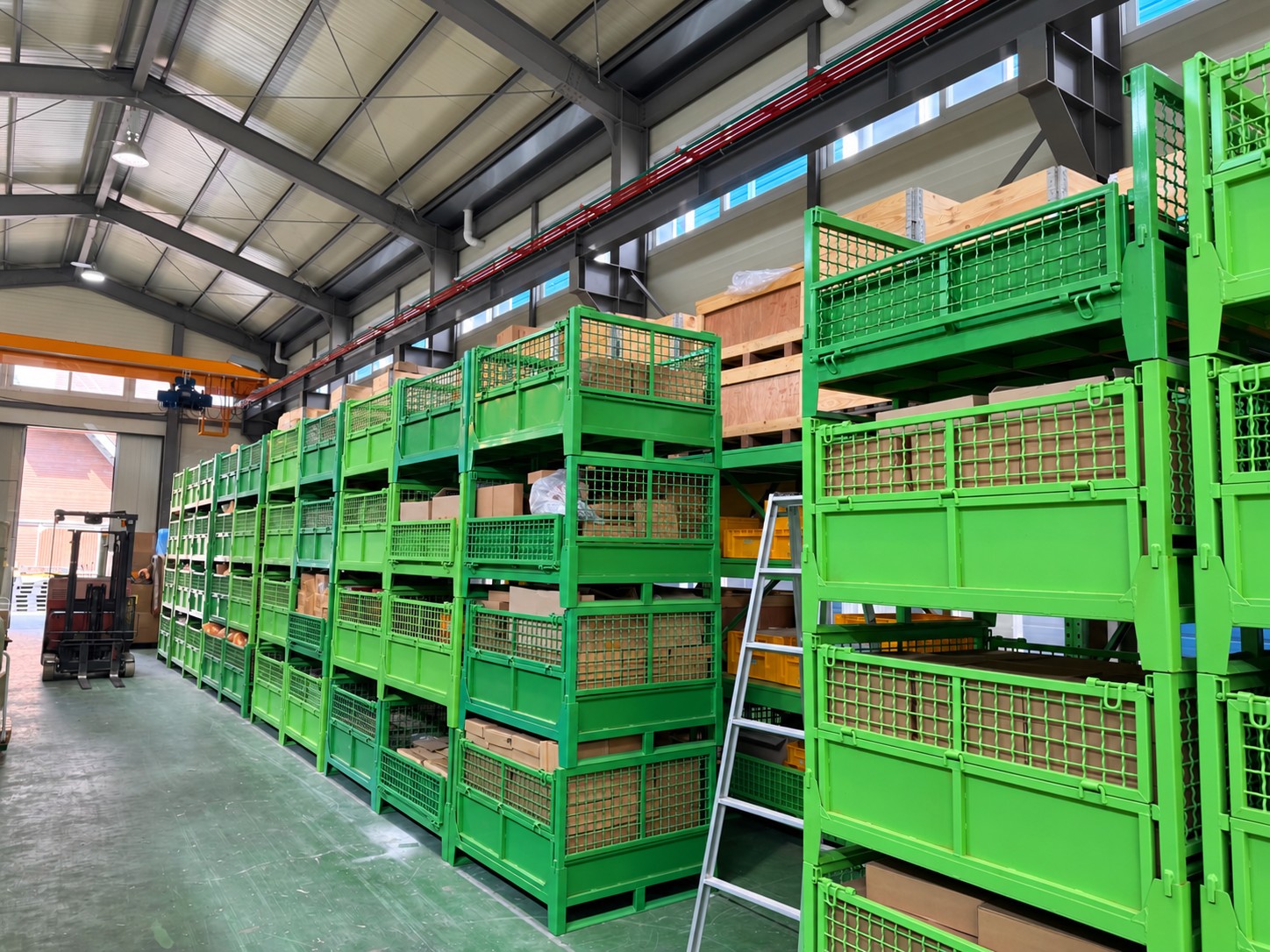 Rows of warehouse storage racks holding boxed and crated engine spare parts